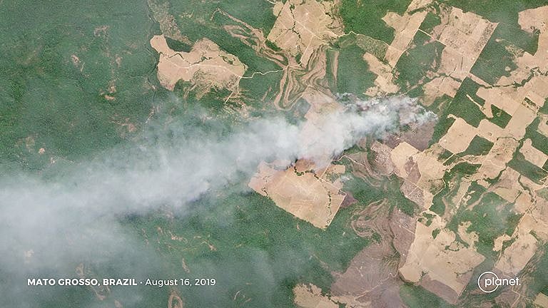 This Planet.com image shows a fire burning in an area of recent forest clearing in Mato Grosso, Brazil.