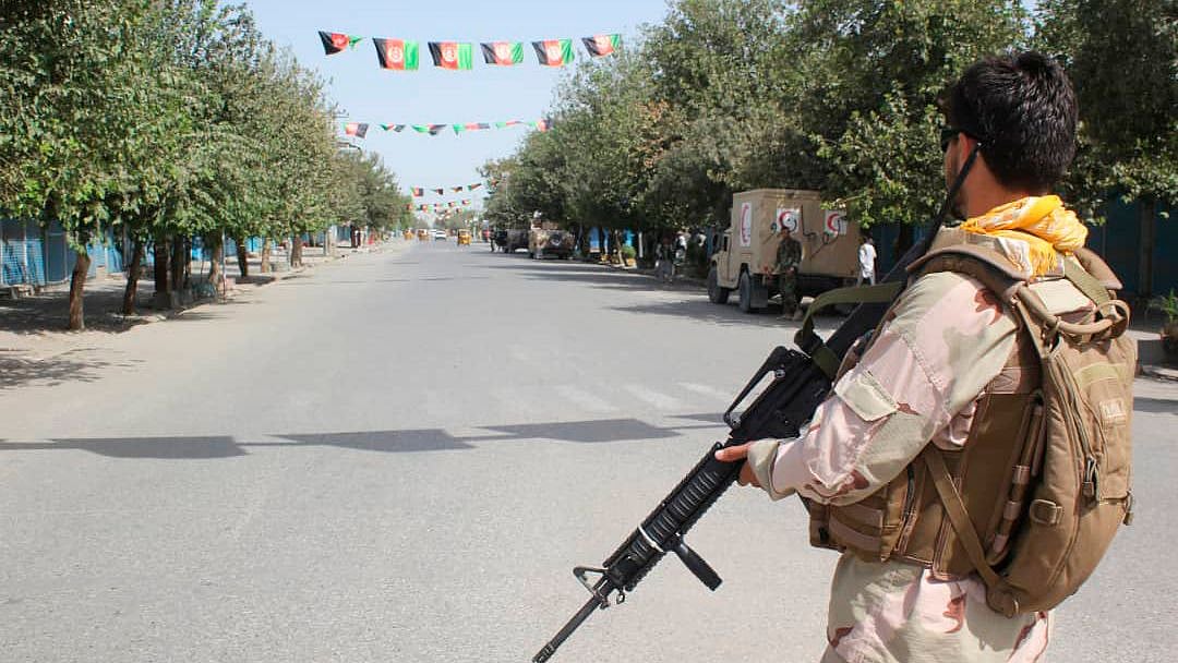 Afghan security forces stand guard during a fight against Taliban fighters in Kunduz province north of Kabul, Afghanistan.