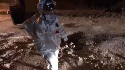 Bengaluru: An artist dressed as astronaut walks on a Bengaluru road. (Photo: IANS)
