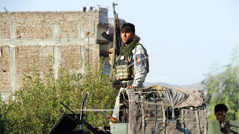 Afghan security forces arrive near the site of a suicide bombing as militants attempted to storm a government office in Jalalabad.