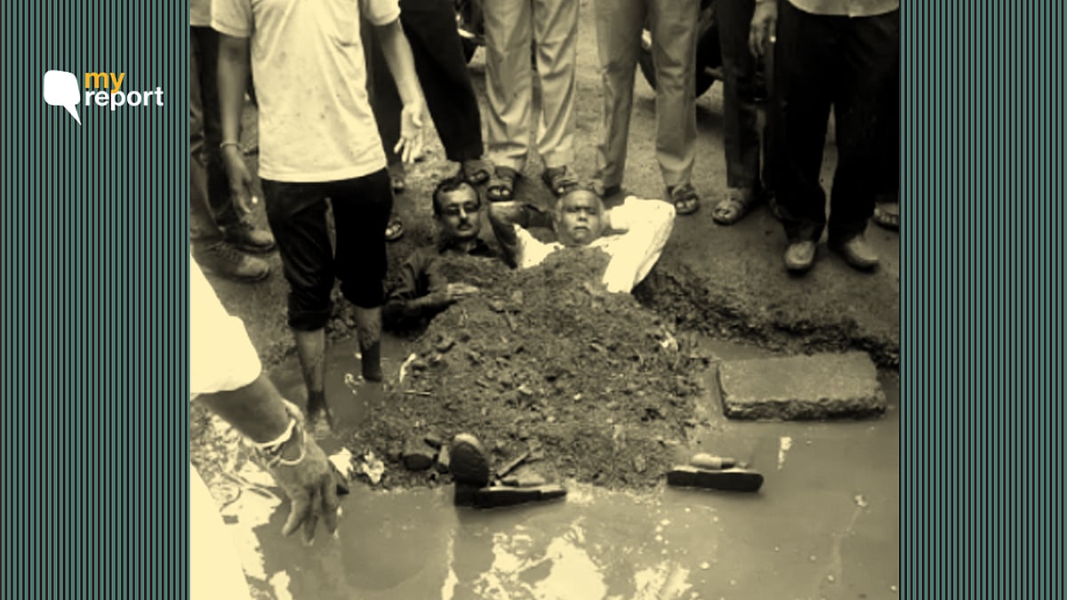 Lakshman Bathwar and his friend buried themselves in a pothole as protest against the condition of the road.