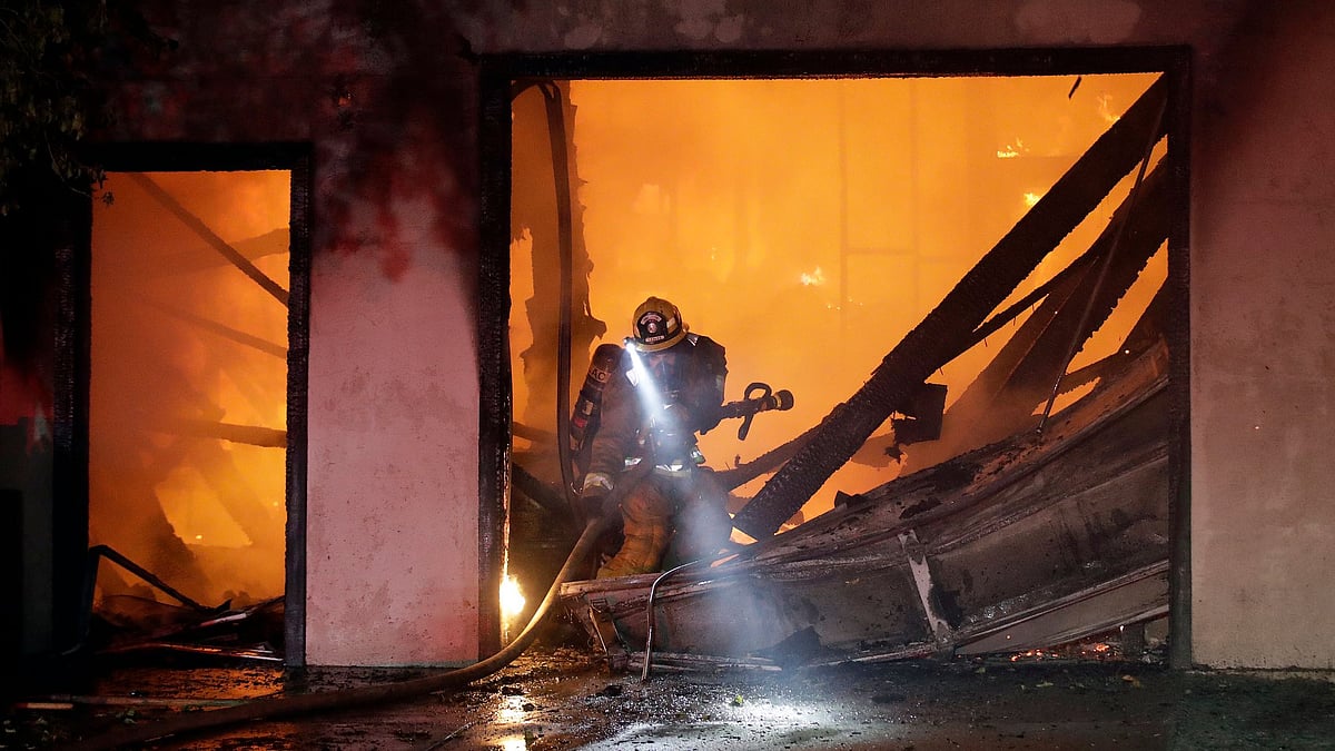 A firefighter works the scene of a wildfire-ravaged home Thursday, 24 Oct 2019, in Santa Clarita, Calif.