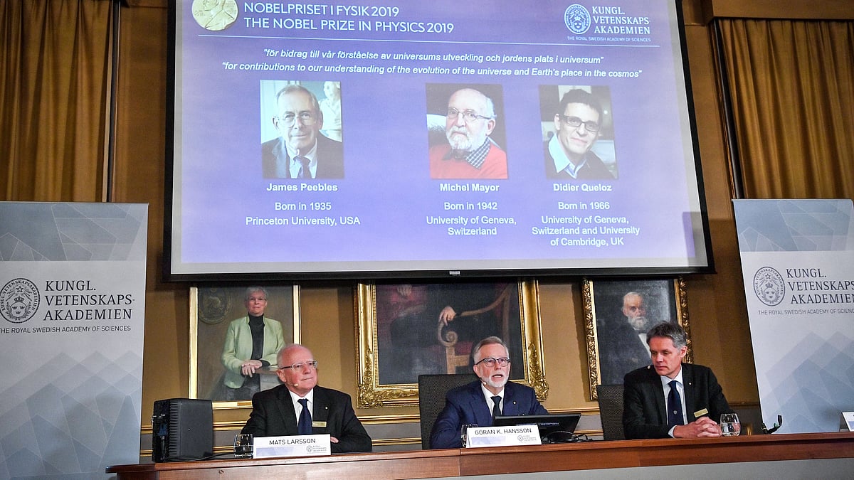 Goran K Hansson, secretary general of the Royal Swedish Academy of Sciences, and academy members Mats Larsson and Ulf Danielsson, announce the winners of the 2019 Nobel Prize in Physics. 
