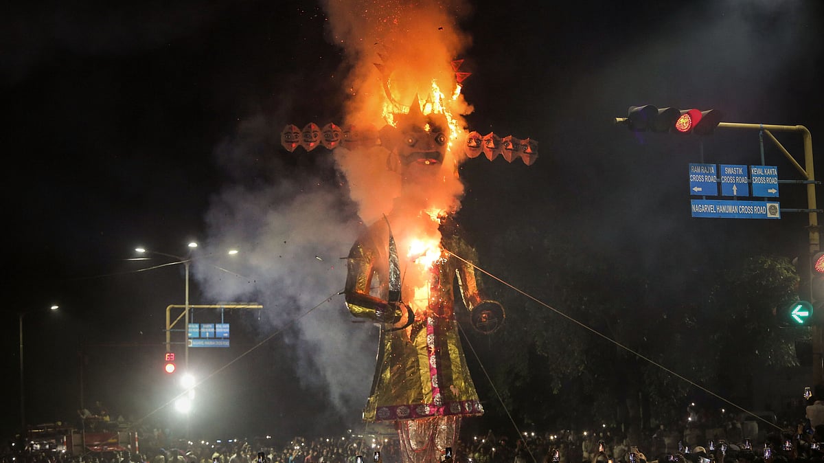 People click pictures with their mobile phones as an effigy of demon-king Ravana is burnt during Dussehra celebrations.