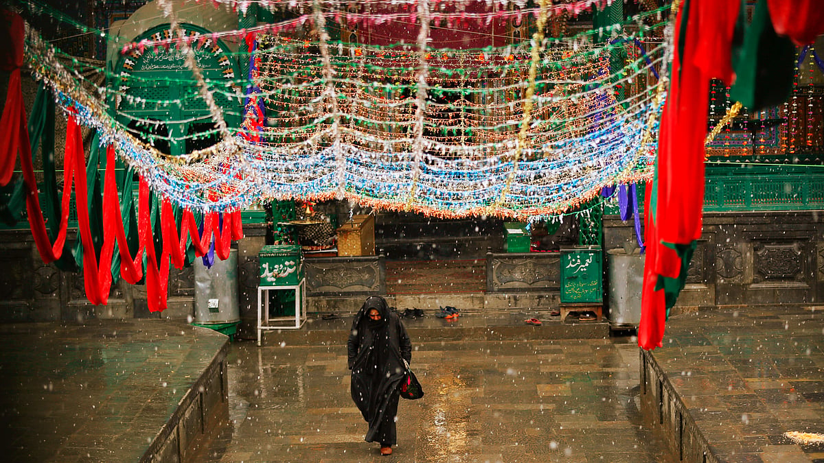 A Kashmiri Muslim woman walks outside a Muslim shrine as it rains in Srinagar. (Image used for representational purposes.)