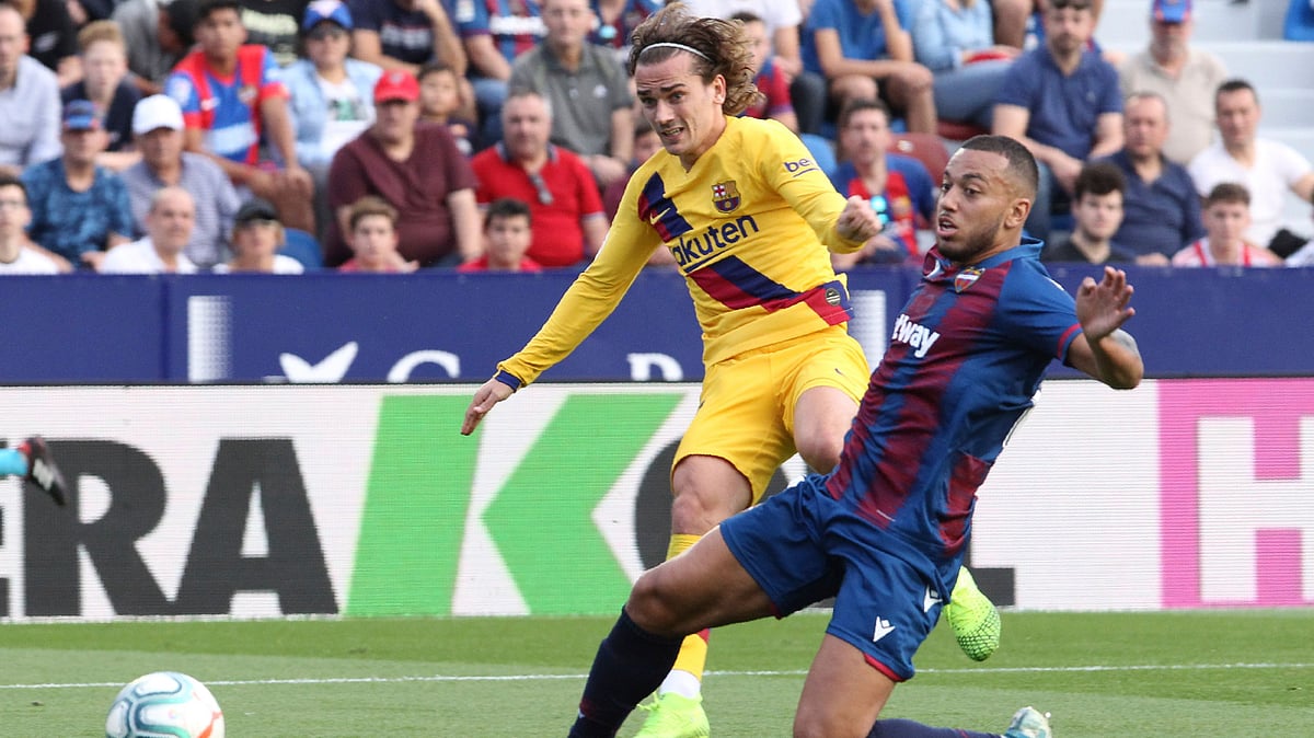 Barcelona’s Antoine Griezmann kicks the ball past Levante’s Ruben Vezo during the Spanish La Liga soccer match in Valencia, Spain.