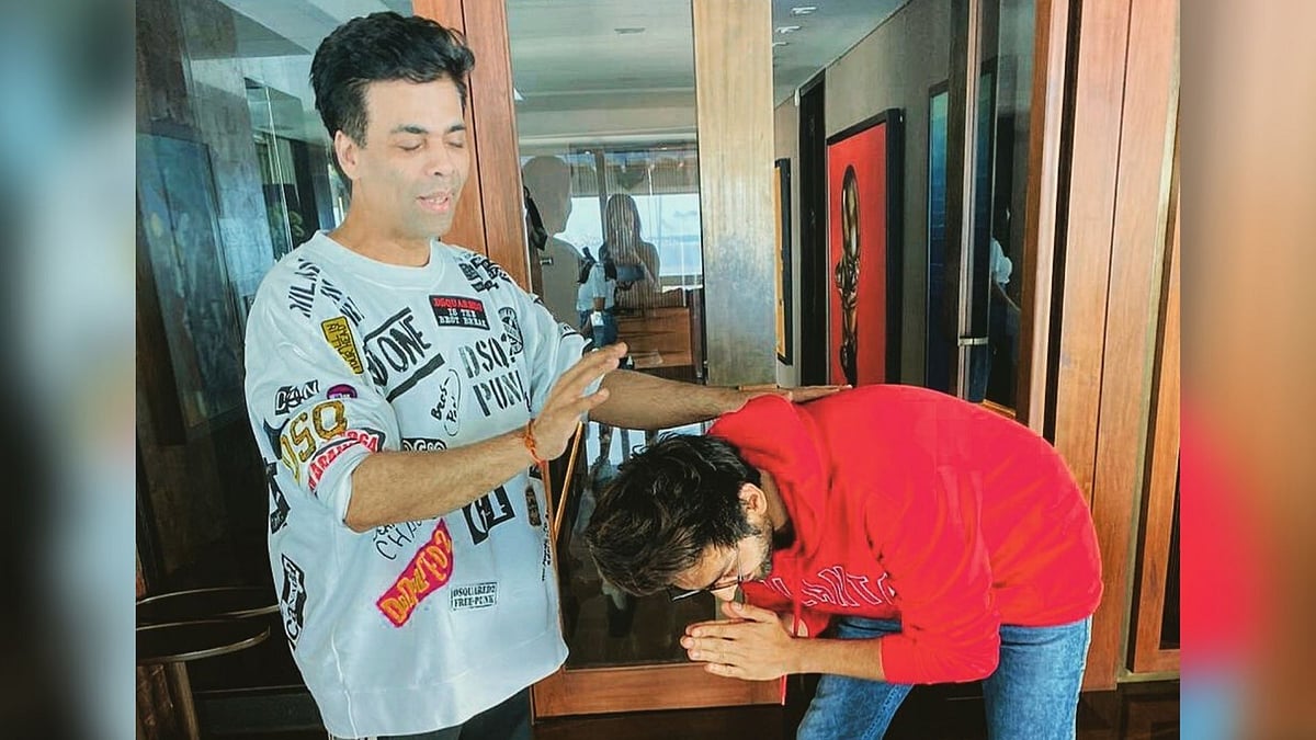 Karan Johar and Kartik Aaryan caught in a religious moment.