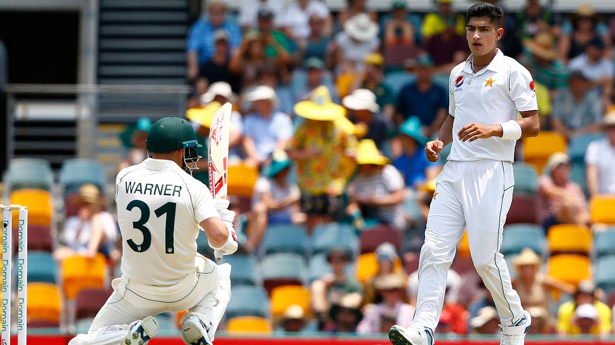 Pakistan’s Naseem Shah, right, stares at Australia’s David Warner, left, after he bowled a bouncer during their cricket test match against Australia in Brisbane, Australia.