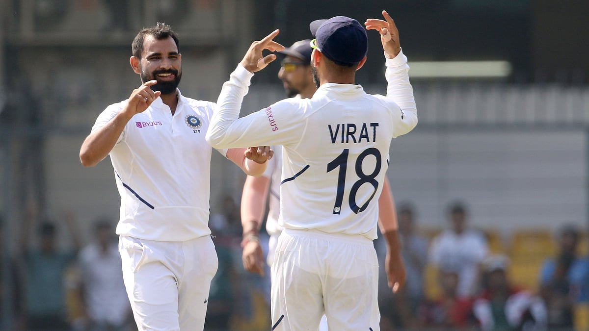 Mohammed Shami celebrates the wicket of Mohammad Mithun with captain Virat Kohli.