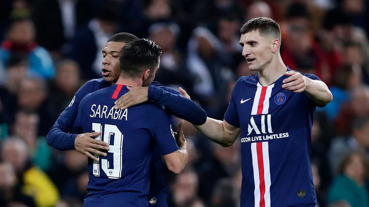Paris Saint-Germain salvaged a 2-2 draw with Real Madrid to clinch first place in Group A of the Champions League.