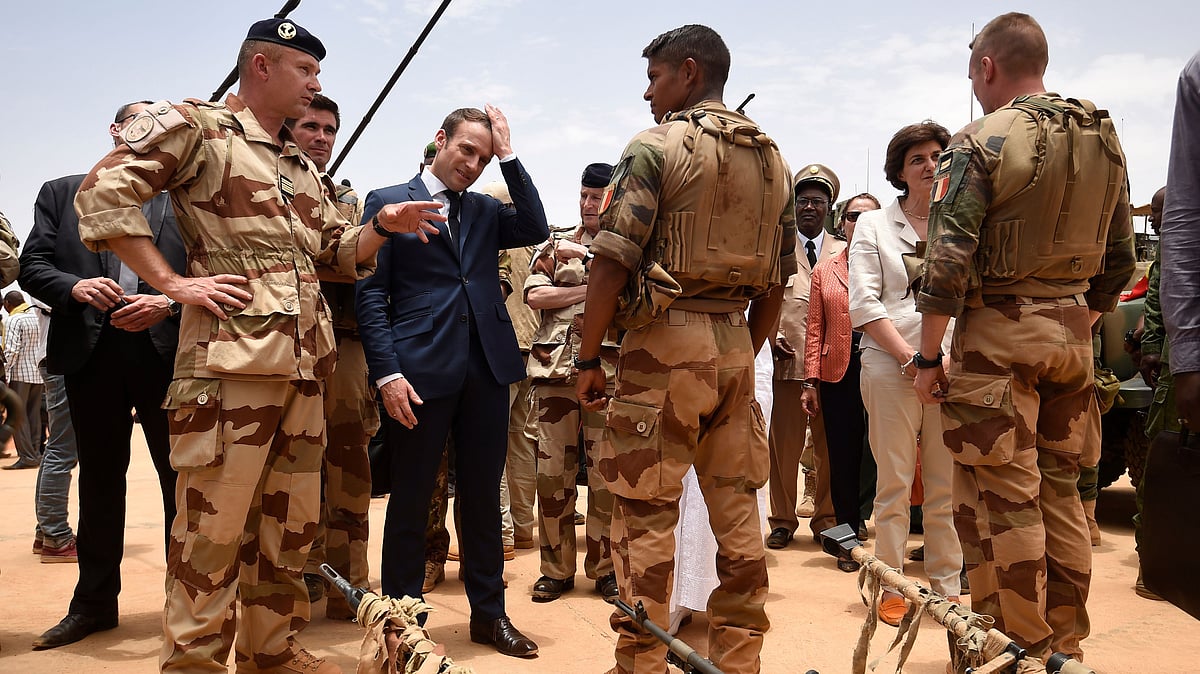 In 19 May 2017 file photo, French President Emmanuel Macron, center left, visits soldiers of Operation Barkhane, France’s largest overseas military operation, in Gao, Northern Mali. 