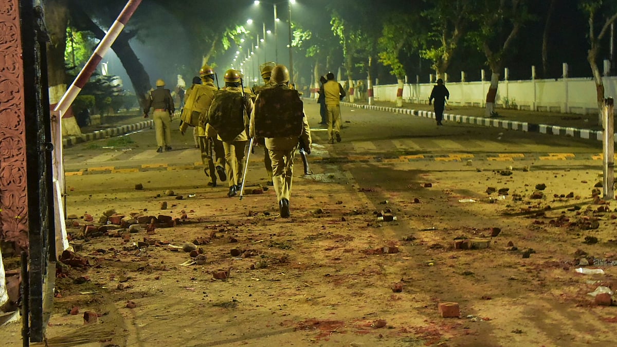 Police personnel conduct a march after violence broke out at protests against Citizenship Amendment Act, at Aligarh Muslim University (AMU).