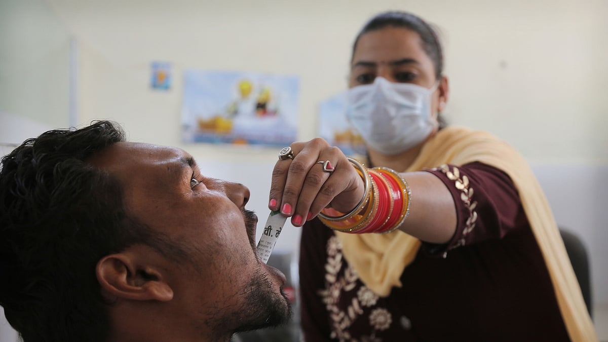 A medic administers medicine to a recovering drug addict at a de-addiction center in Kapurthala, in the northern Indian state of Punjab.