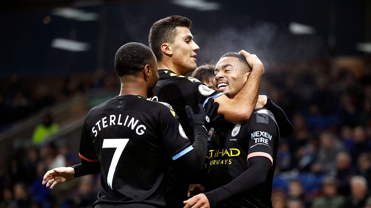 Manchester City’s Gabriel Jesus, right, celebrates scoring his sides first goal of the game against Burnley, with teammates during their Premier League soccer match at Turf Moor in Burnley, England.