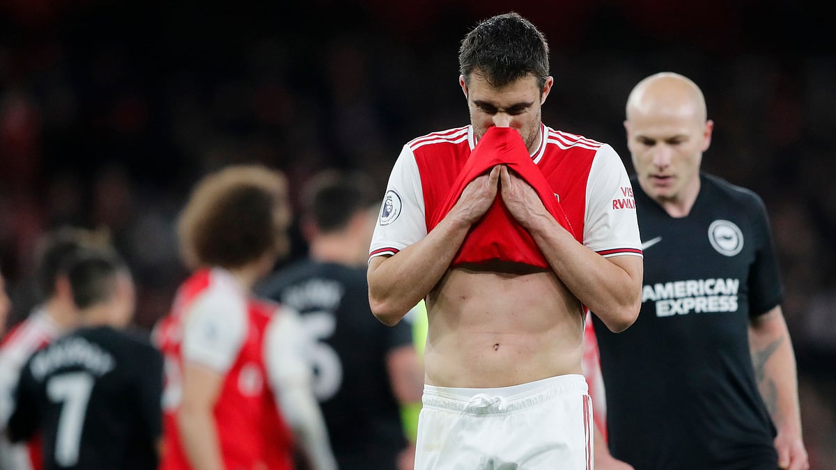 Arsenal’s Sokratis Papastathopoulos wipes his face during the English Premier League match between Arsenal and Brighton, at the Emirates Stadium in London.