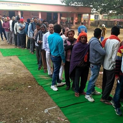 Palamu: Voters queue up outside a polling station to cast their votes for the first phase of Jharkhand Assembly elections, in Palamu on Nov 30, 2019. (Photo: IANS/PIB)
