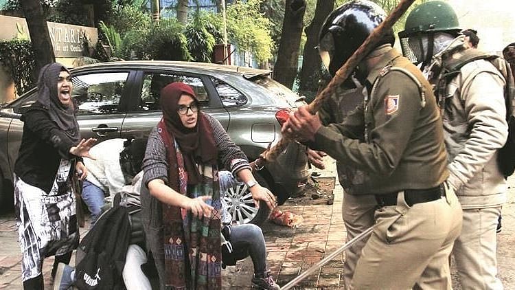 Image of students of Jamia trying to protect another student from police violence, used for representational purposes.