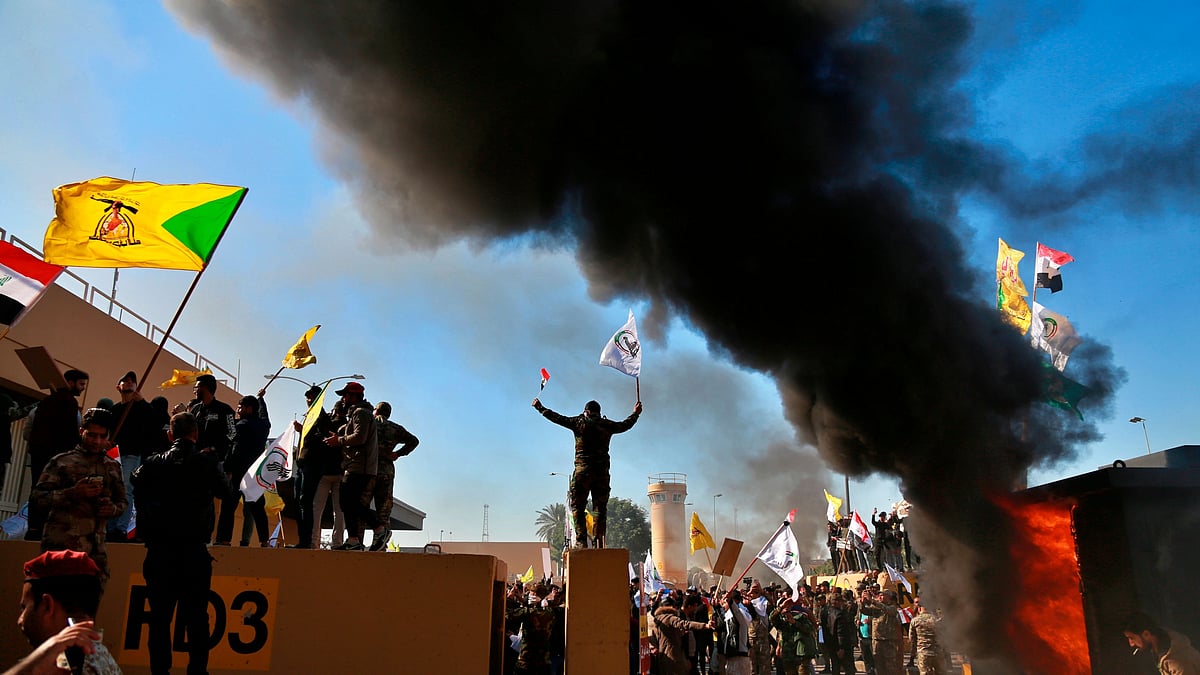 Protesters burn property in front of the US embassy compound, in Baghdad, Iraq, Tuesday, 31 December 2019.