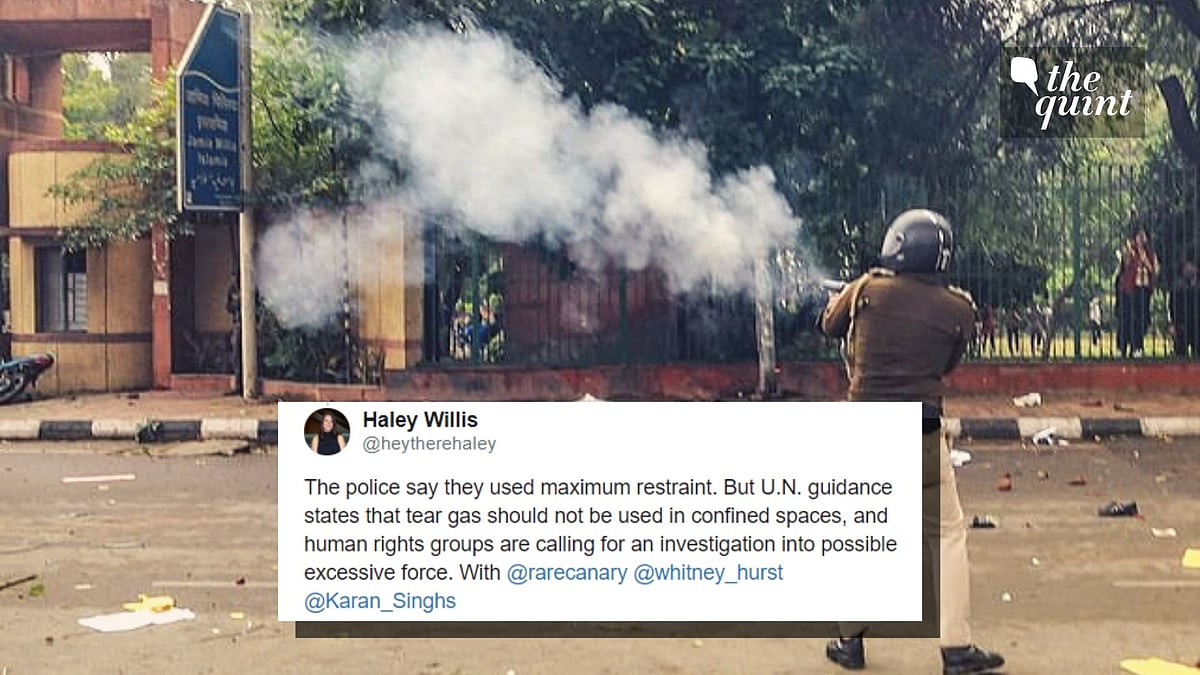 Policeman firing a tear gas canister near Jamia Millia Islamia university.