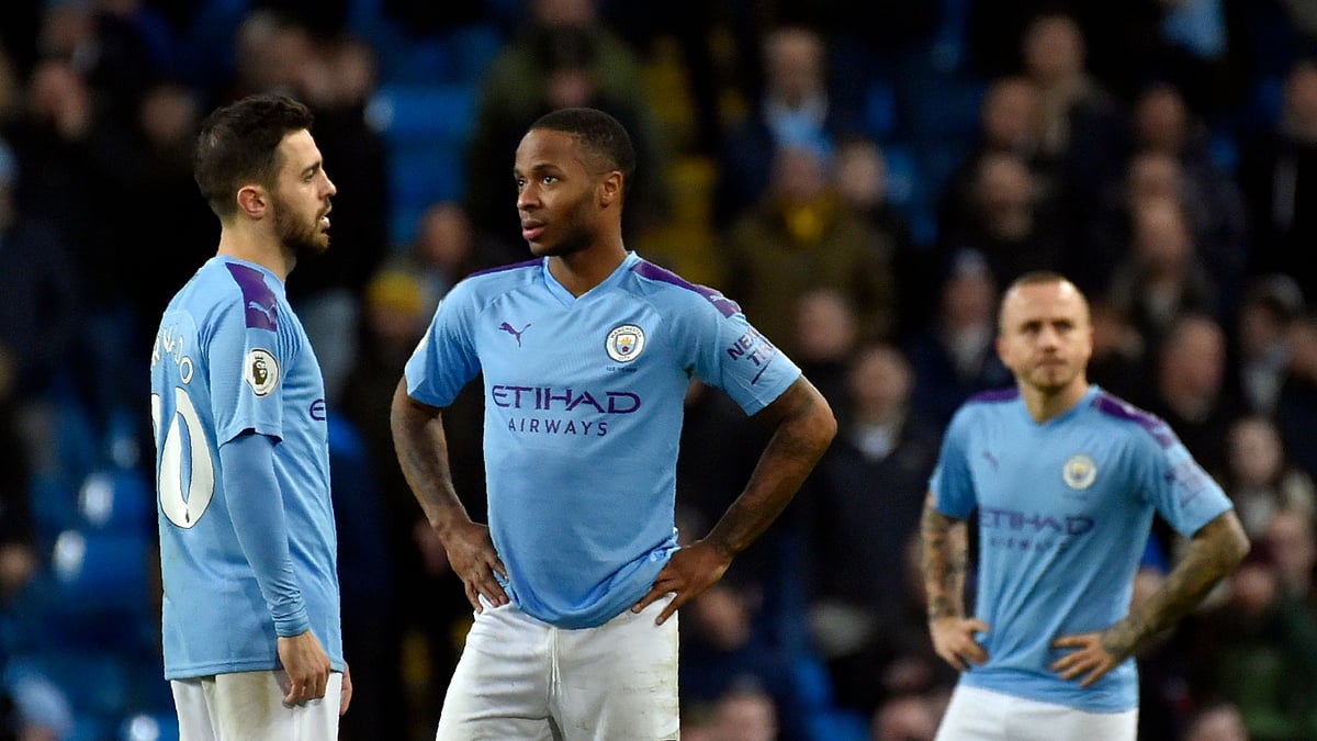 Manchester City’s Bernardo Silva, left, speaks with Manchester City’s Raheem Sterling, center, during the English Premier League soccer match between Manchester City and Manchester United.