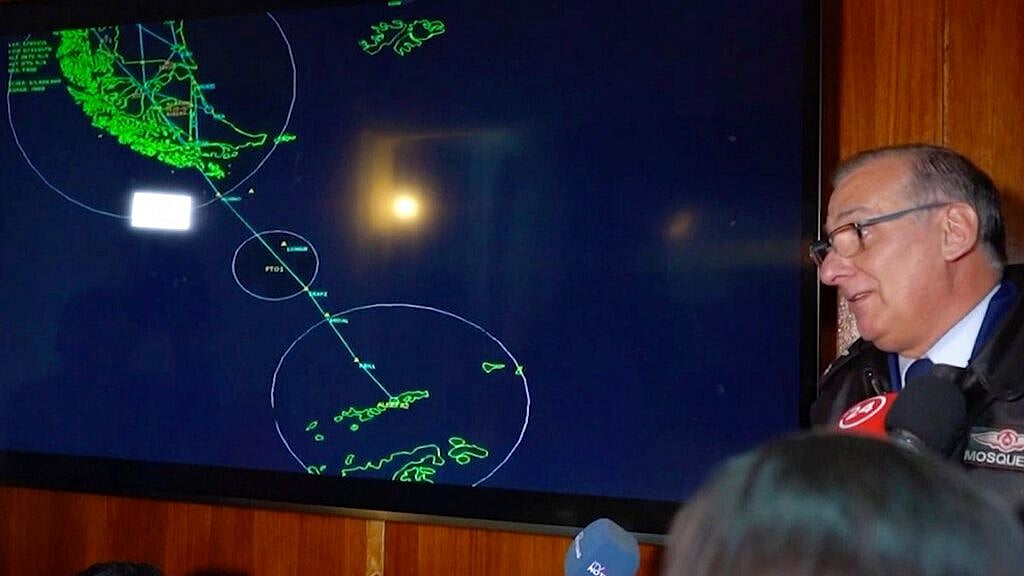 Gen. Eduardo Mosqueira, of the Fourth Air Brigade speaks to the media next to a map of the area where the airplane is missing, in Punta Arenas, Chile. 