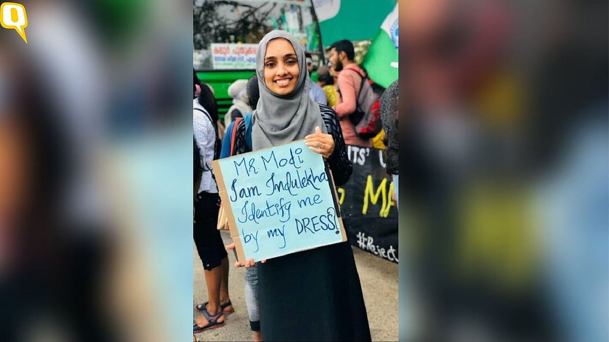Photo of Indulekha wearing hijab, holding a placard that read: ‘Identify me by my dress?’ went viral.