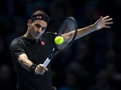 File: Roger Federer of Switzerland returns a shot during the singles match against Dominic Thiem 