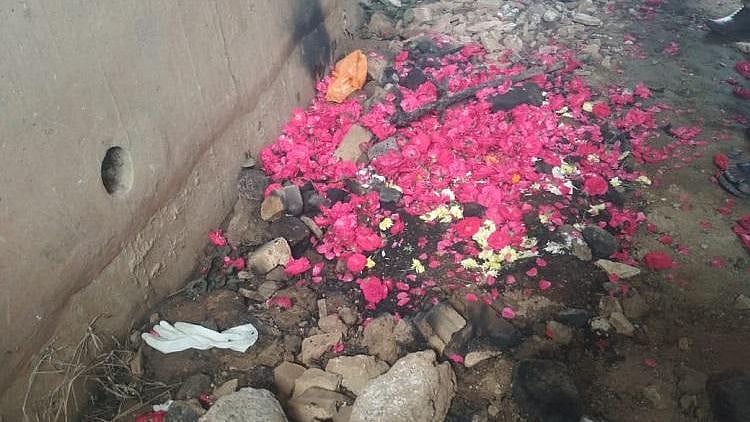 Crowds bring flowers to reported encounter site.