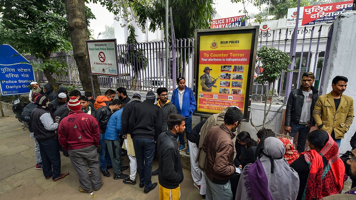 New Delhi: Family members of the people arrested for violence during a rally against the Citizenship Amendment Act (CAA), last evening, wait for their release outside Daryaganj police station, in New Delhi, Saturday, Dec. 21, 2019