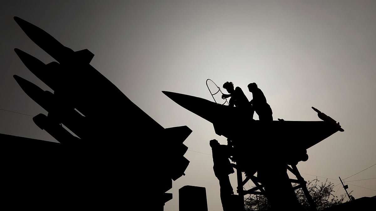 Workers give final touches to a model of Rafale fighter jet at the Indian Air Force tableaux during a press preview for the Republic Day parade, in New Delhi on 22 January. Image used for representational purposes. 