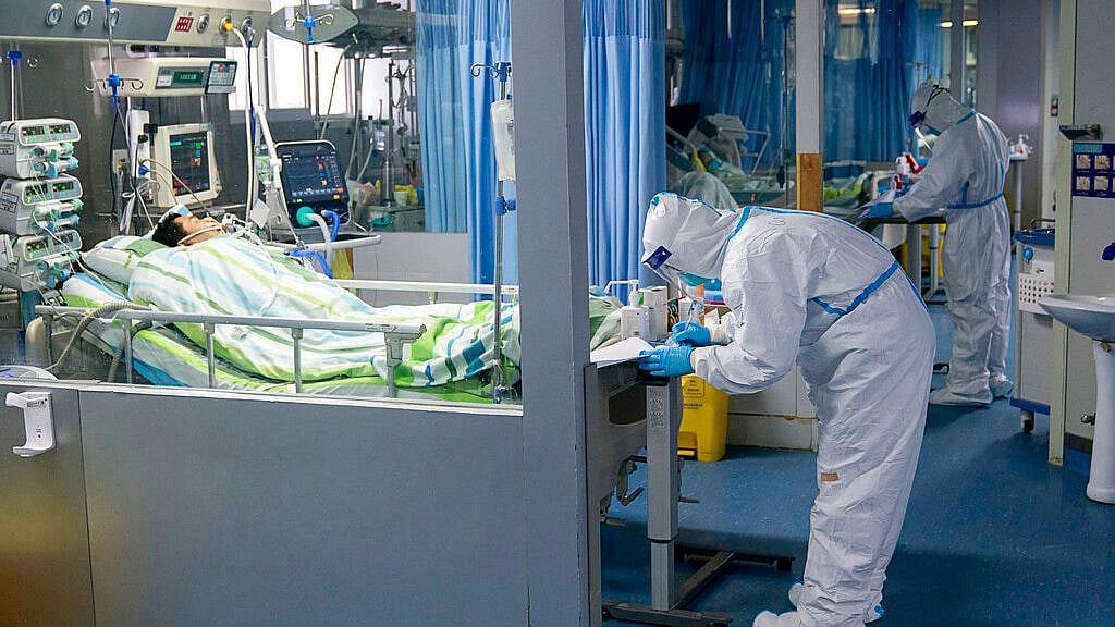 In this Friday, Jan. 24, 2020, photo released by China’s Xinhua News Agency, a medical worker attends to a patient in the intensive care unit at Zhongnan Hospital of Wuhan University in Wuhan in central China’s Hubei Province. 