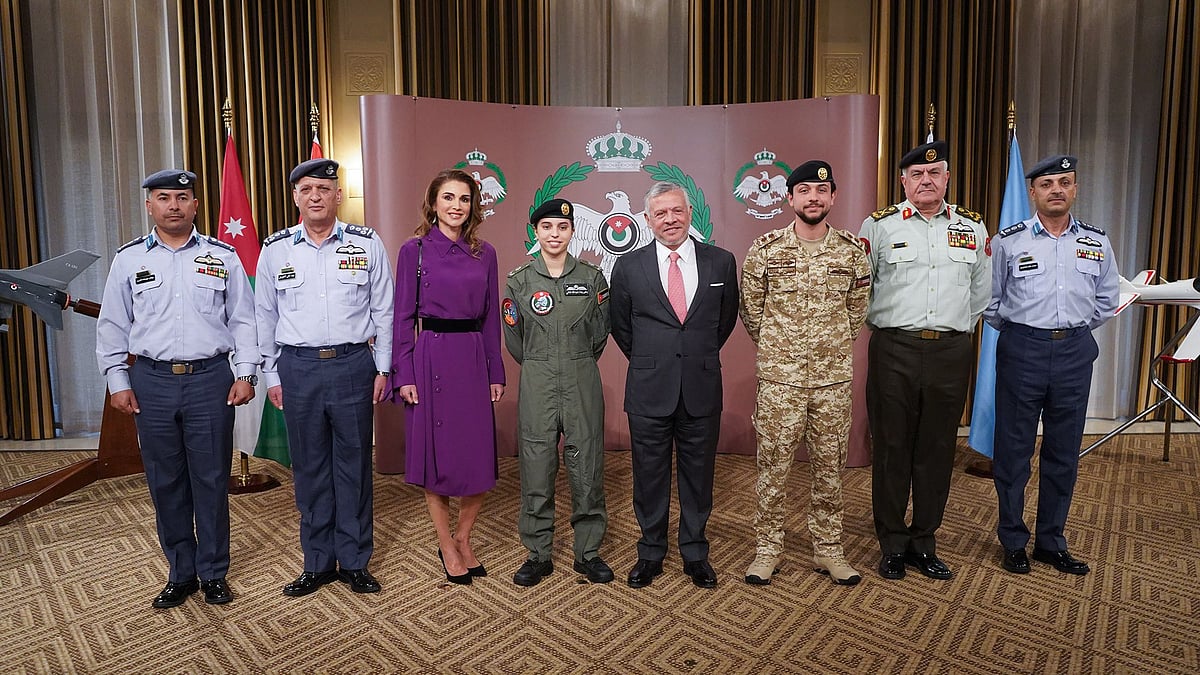 His Majesty King Abdullah II presents Princess Salma with her wings at a ceremony.