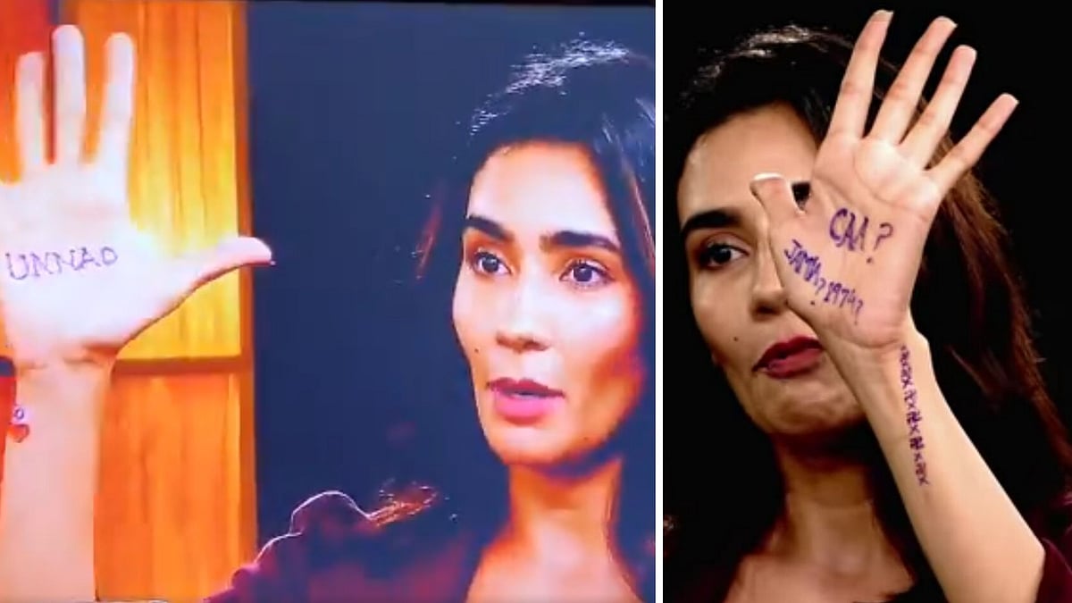 Geetika Vidya Ohlyan writes the words Unnao and CAA on her palms. 