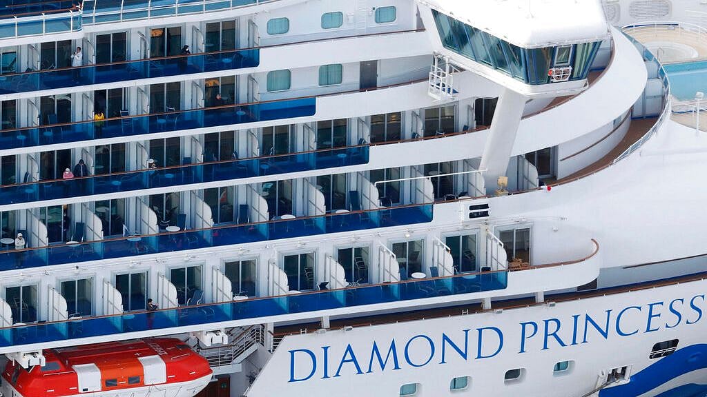 Some passengers seen on the Diamond Princess as the cruise ship is anchored at Yokohama Port for supplies replenished in Yokohama, south of Tokyo, Thursday, 6 February 2020.