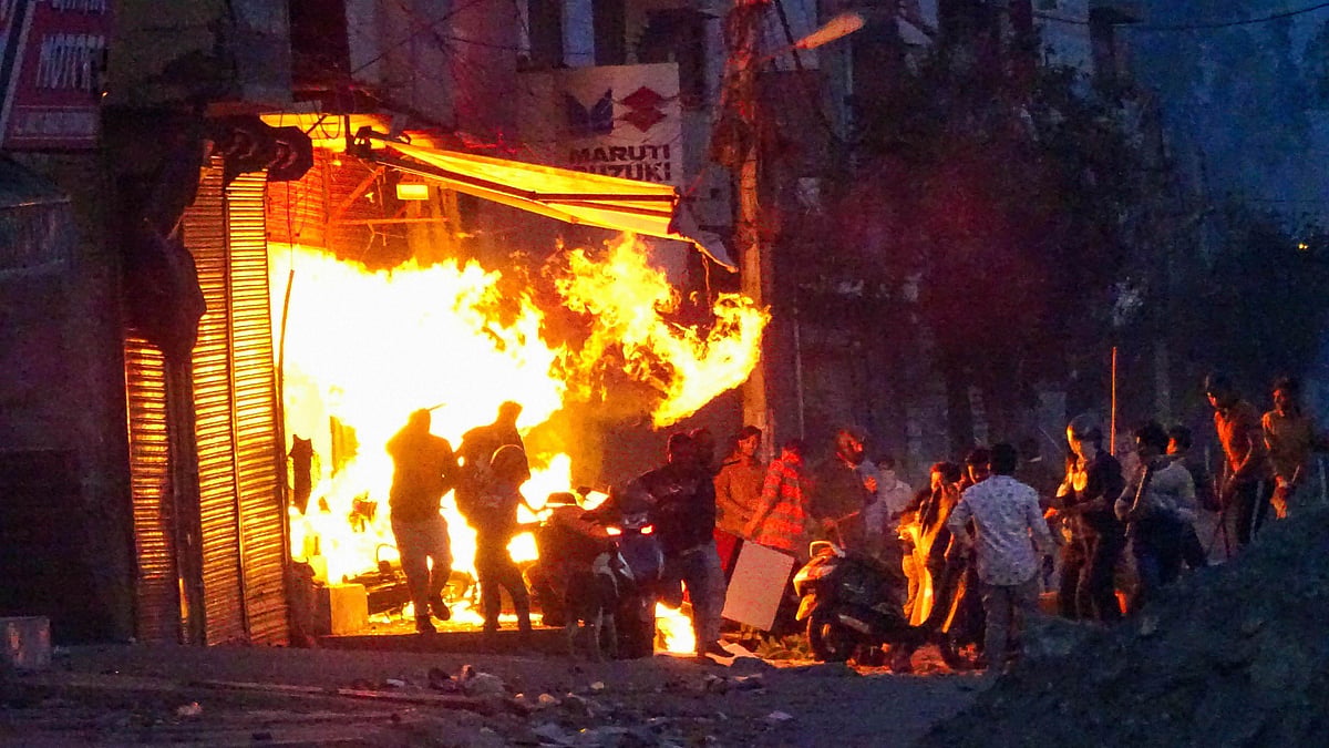  Rioters set ablaze a shop during clashes between those against and those supporting the Citizenship (Amendment) Act in at Gokalpuri in northeast Delhi.