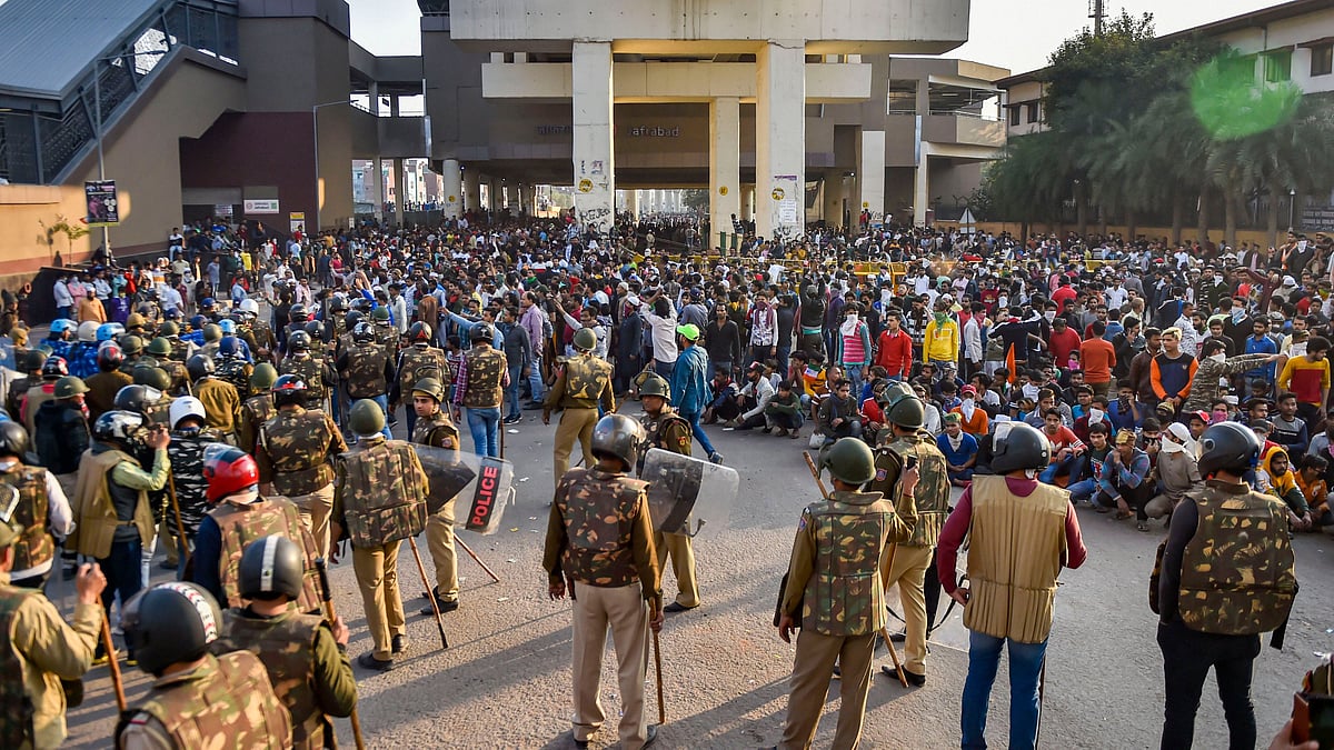 Security personnel stand guard during clashes between those supporting and against the Citizenship (Amendment) Act in northeast Delhi on Tuesday, 25 February.