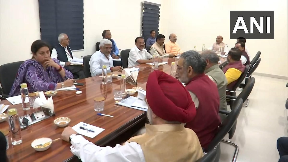 Visuals from the meeting stood showed its participants seated next to each other around a conference table.