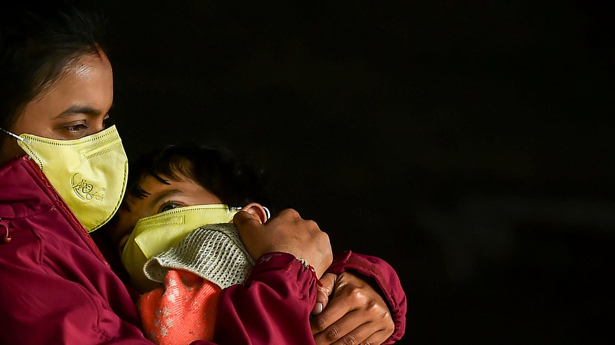 Passengers wear protective face masks in wake of novel coronavirus pandemic at New Delhi Railway Station, Sunday, March 15, 2020