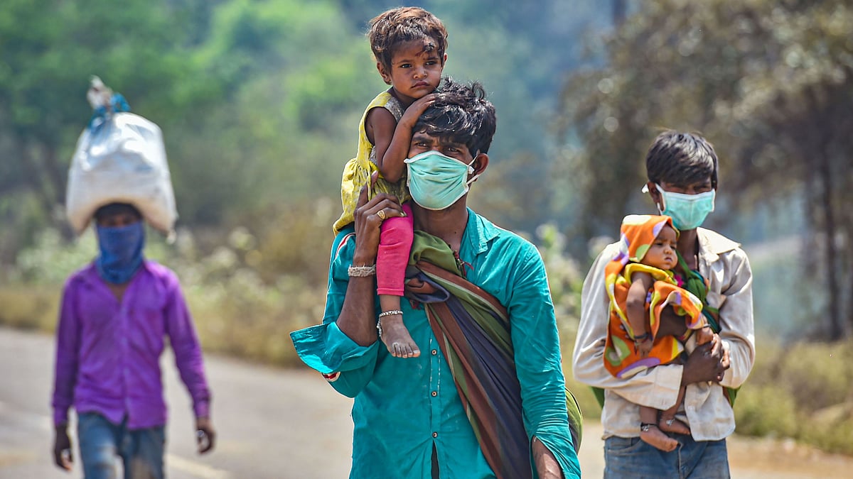 Migrant workers from Madhya Pradesh walk along the Mumbai-Ahmedabad highway, following the coronavirus lockdown, in Palghar, Monday, 30 March. Image used for representational purposes.&nbsp;