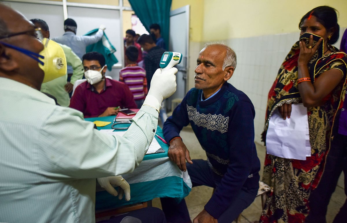 A medic conducts screening of a patient in the wake for novel coronavirus , Tuesday, March 17, 2020.