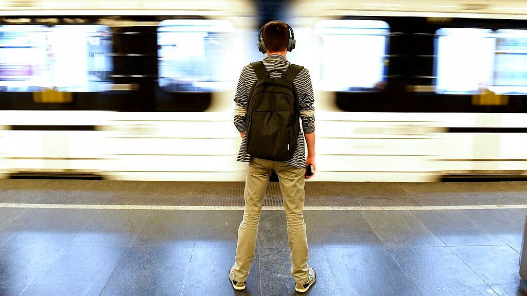 A lonely passenger stands on the Deak ter metro station in Budapest, Hungary, Thursday, March 19, 2020. Due to the coronavirus epidemic, the number of travelers on public transport routes has dropped significantly