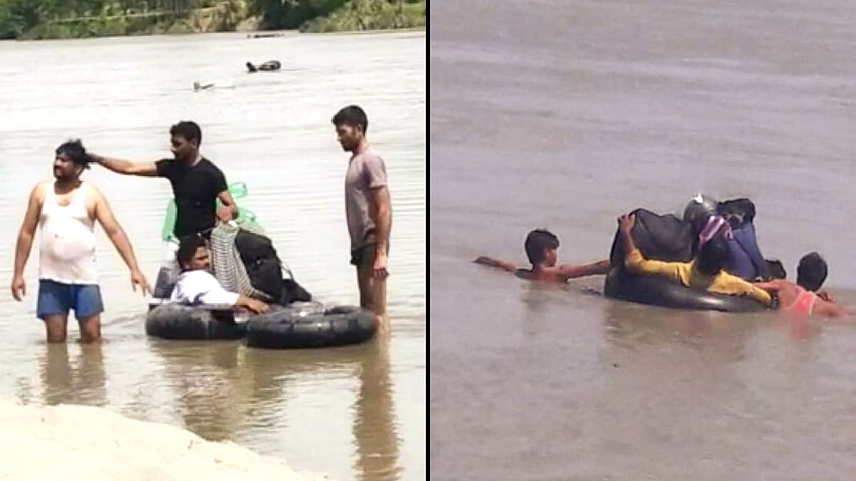 Labourers cross the Yamuna river near Panipat border in rubber tubes.