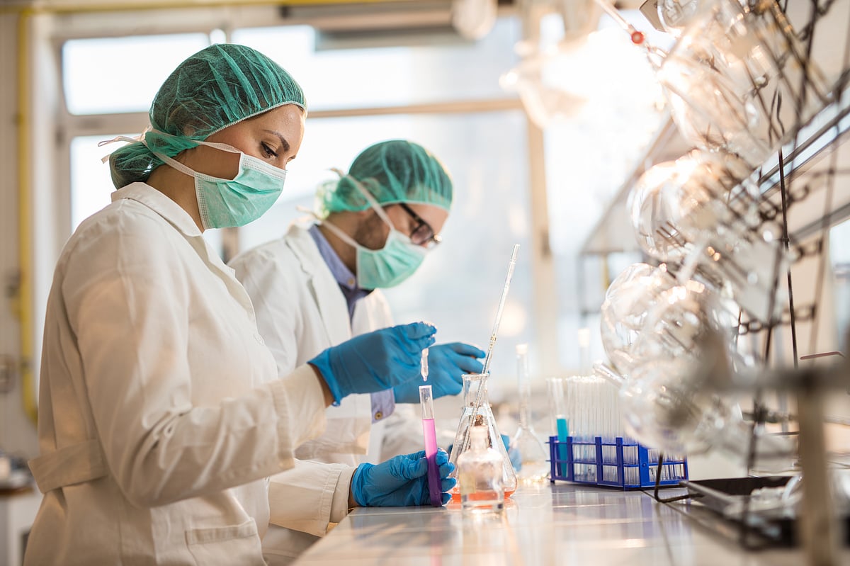 Chemists examining chemical substances in test tubes while working on medical research in the laboratory.