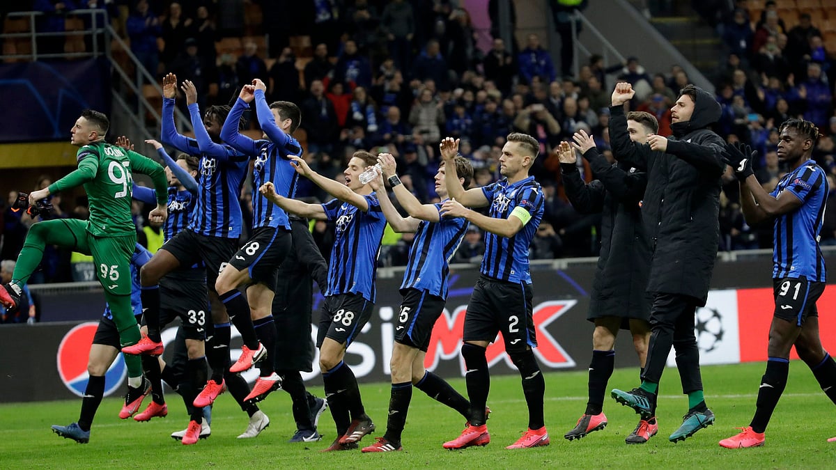 In this Wednesday, Feb. 19, 2020 file photo, Atalanta players celebrate at the end of the Champions League round of 16, first leg, soccer match between Atalanta and Valencia at the San Siro stadium in Milan, Italy. 