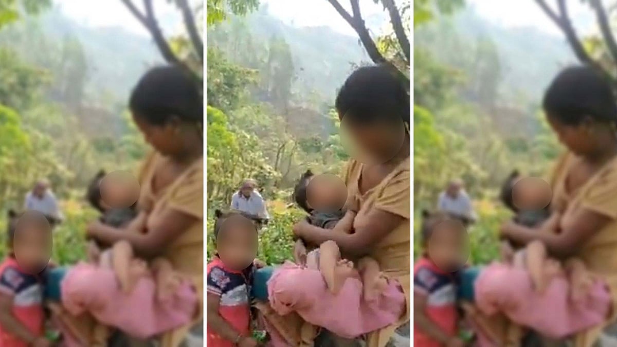 A woman worker breastfeeds her baby at a tea garden in West Bengal's Darjeeling amid the COVID pandemic.