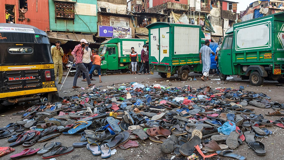 Footwear of protestors seen lying on the road after after police action on migrant workers, outside Bandra Railway Station in Mumbai on Tuesday.