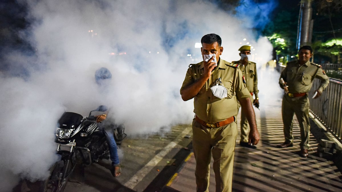 A policeman covers his face as a municipal worker fumigates an area during the nationwide lockdown in Prayagraj. (Image for representation)