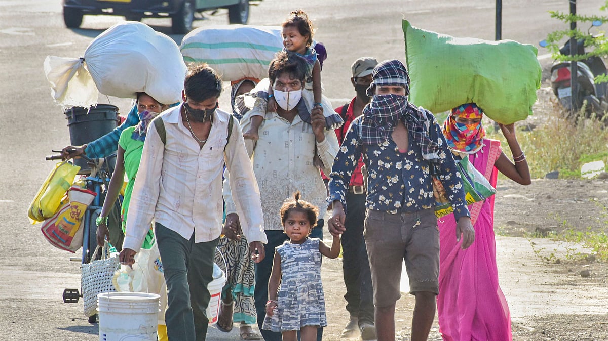 Migrants from Karnataka walk along a road to reach thir native places,amid ongoing COVID-19 lockdown, in Solapur, Maharashtra, Tuesday, May 12, 2020