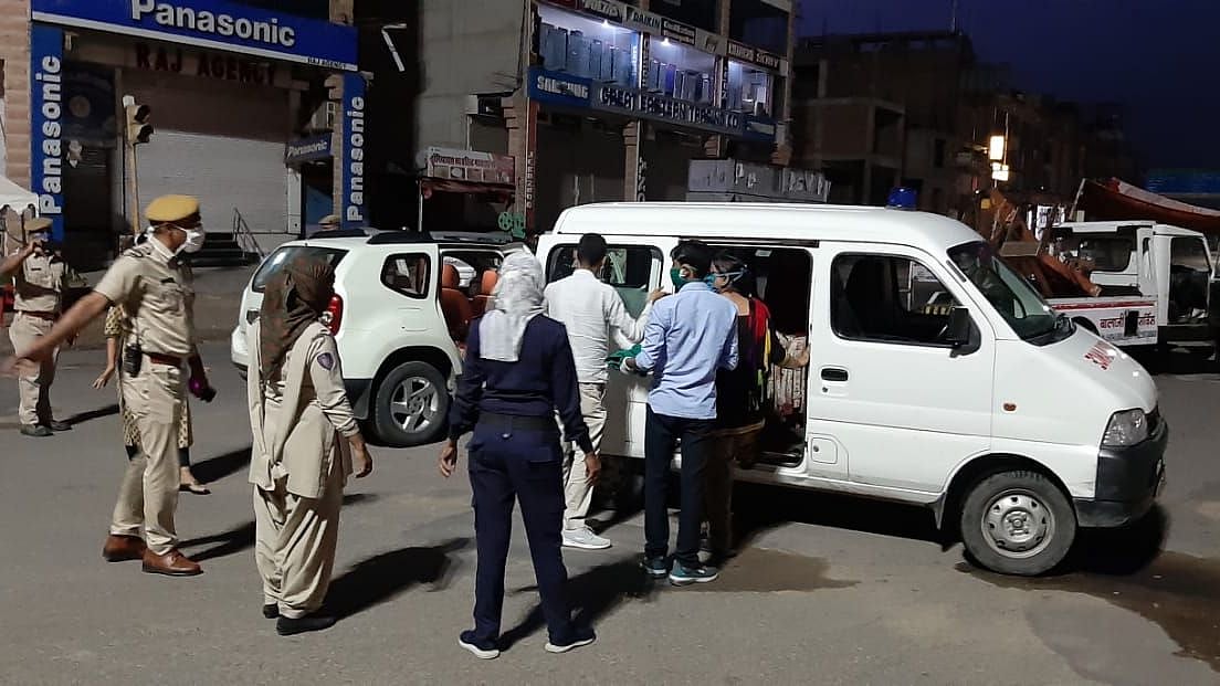 Police personnel come to the assistance of a pregnant woman.