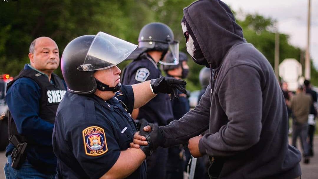 Policemen stand in solidarity with protesters in US